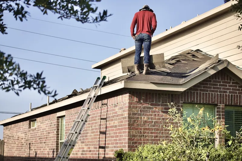Professional roofer working on a residential roof in Upperville